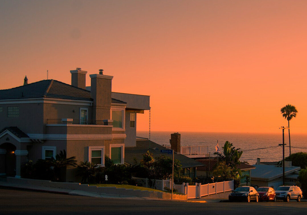Minimalist beach house with travertine terrace at sunset